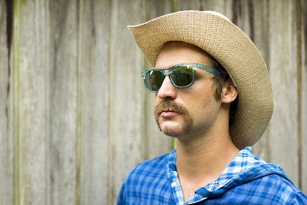 istock cowboy on wooden background 185587046