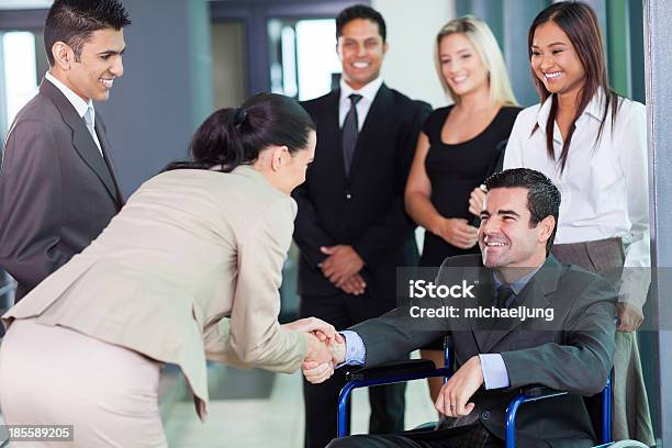 Businesswoman Greeting Handicapped Business Partner Stock Photo - Download Image Now