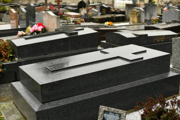 istock Cross on a black marble slab on a grave in a cemetery 1855924392