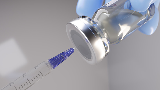Syringe being inserted into a vaccine vial.