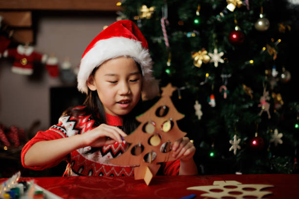 istock young girl making Christmas craft at home 1855932497