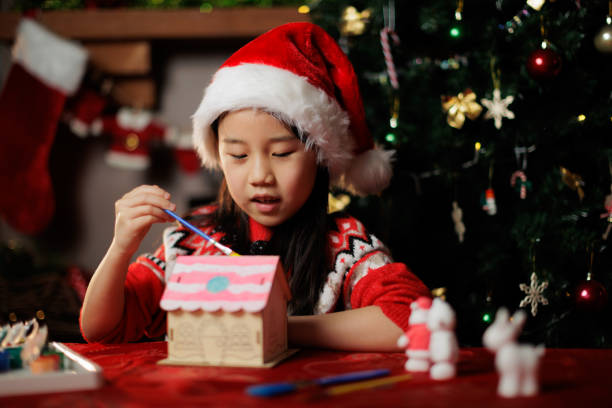 istock young girl making Christmas craft at home 1855932499