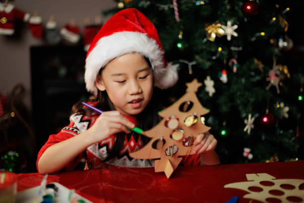 istock young girl making Christmas craft at home 1855932500
