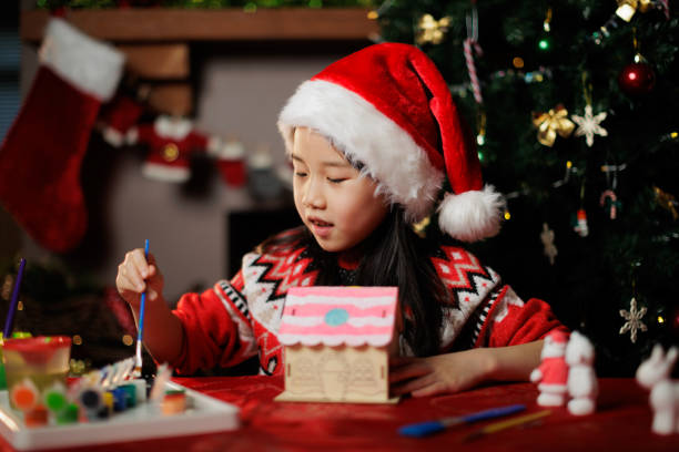 istock young girl making Christmas craft at home 1855932502