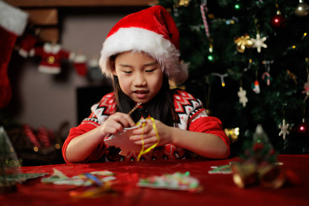 istock young girl making Christmas craft at home 1855933014