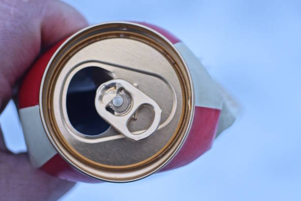 istock hand holding one crumpled open brown aluminum beer can 1855948993