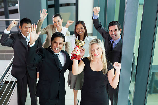 istock young business people wining a trophy 185595543