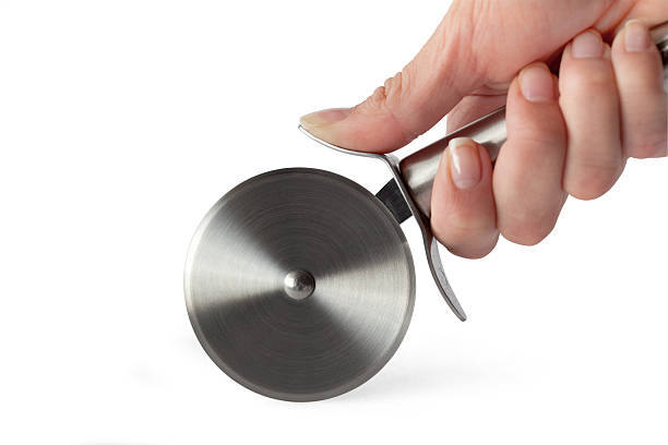 Pizza Cutter in Woman's Hand (With Clipping Path) Pizza cutter in a female hand, with clipping path. pizza cutter stock pictures, royalty-free photos & images