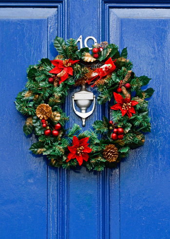 Festive Christmas wreath on door at Christmastime