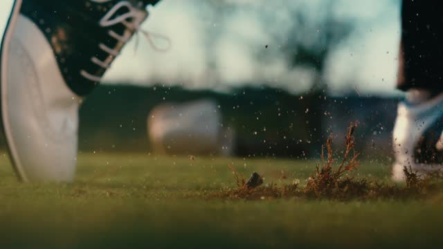 Golfer hitting ball and making big divot, golf shot with dirt flying macro close up 4k in extreme slow motion