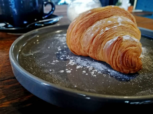 istock Croissant bread served on the ceramic plate at the coffee shop 1856082709