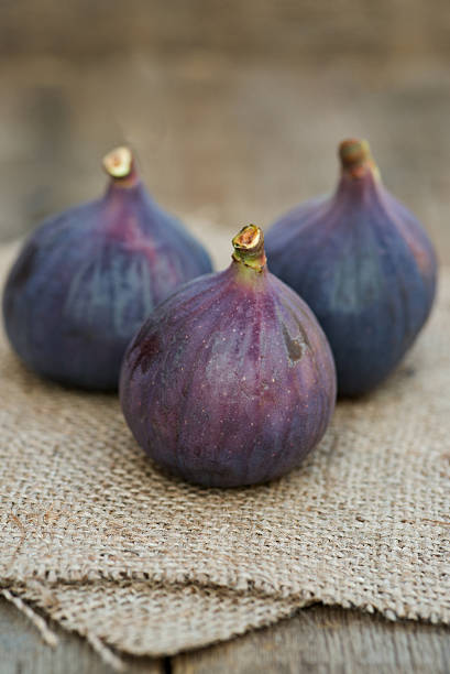 Fresh whole figs on wooden and hessian background