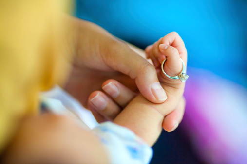 Parent holding baby hand