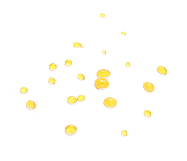 istock Lots of small Honey drops over white background 185612871