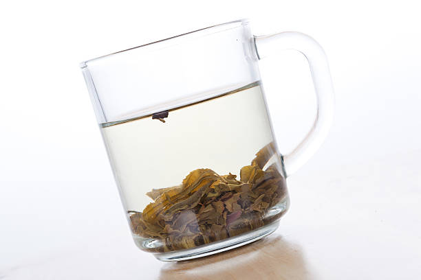 istock Green tea in glass cup with leafs 185614942
