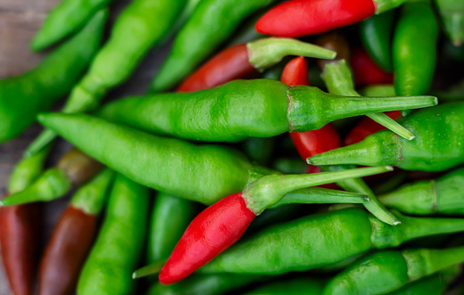 Fresh bird's eye chillies are green and red. There are many names in English, Chilli Padi, Bird's Eye Chilli, Bird Chilli, Thai pepper,