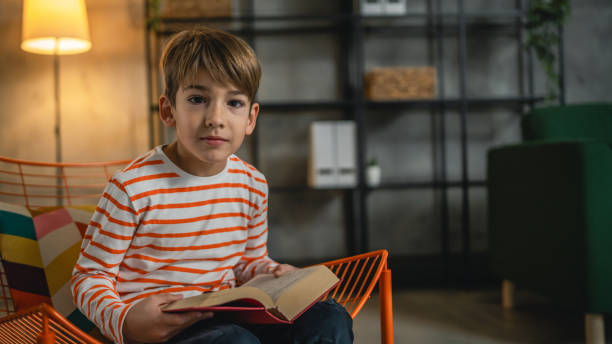 istock One caucasian boy child at home read a book education concept 1856163614