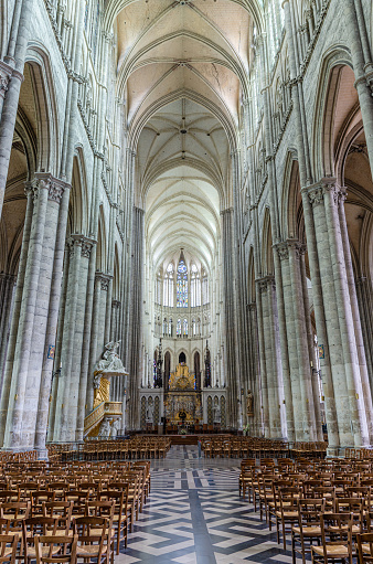 Interior of Amiens Cathedral Basilica of Our Lady Notre-Dame Roman Catholic church with rows of chairs, high columns and baroque high altar, Somme department, Hauts-de-France Region, Northern France