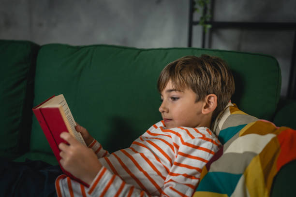 istock One caucasian boy child at home read a book education concept 1856166372