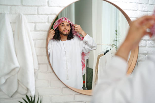 istock Young man getting ready and looking at the mirror in the bathroom 1856172868