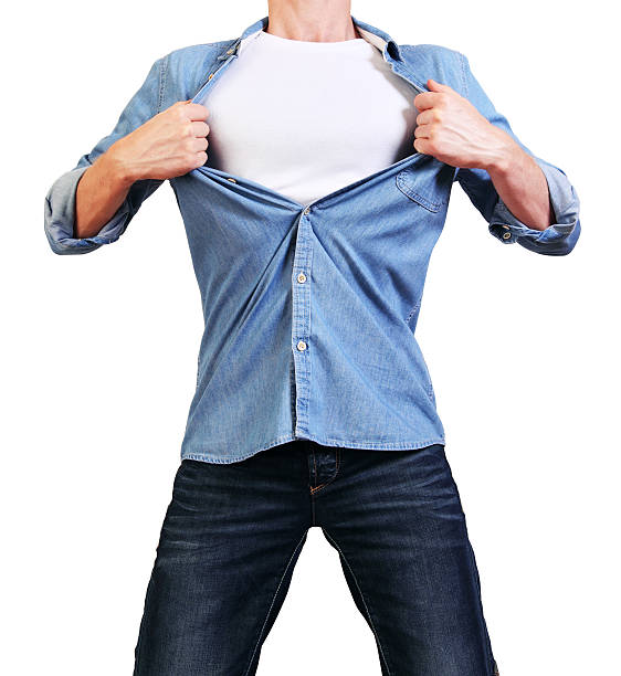 Young man tearing his shirt off isolated on white stock photo