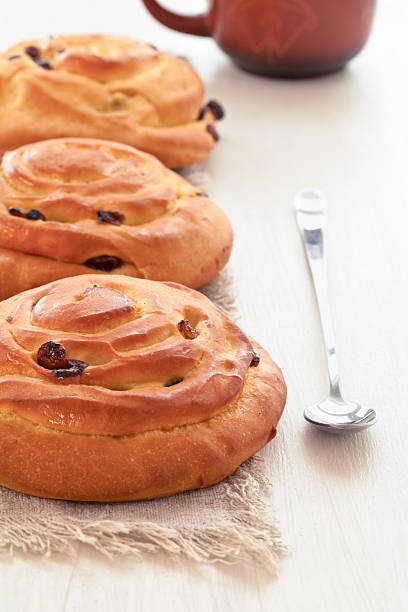 buns with raisins and a cup of tea stock photo