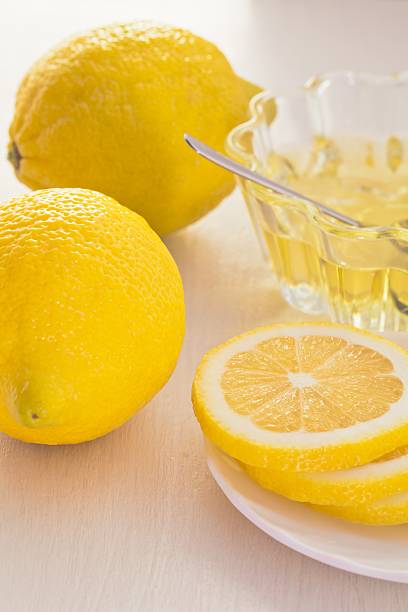 Two yellow lemon and honey glass cup stock photo