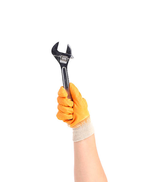 istock Hand in gloves holding wrench. 185620080
