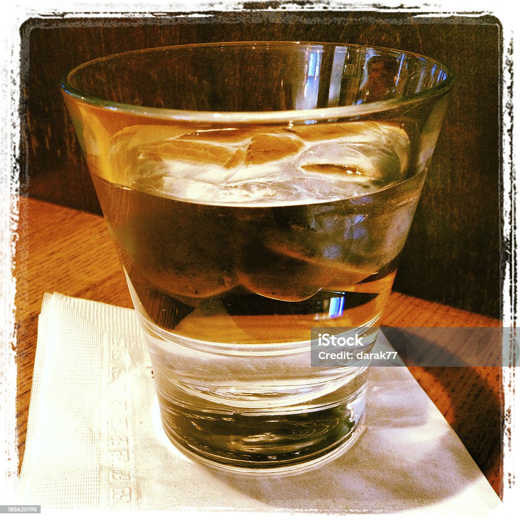 Glass of Ice Water On A Cocktail Napkin A glass of water with ice on a cocktail napkin photographed with an Iphone 4S and edited with Instagram app. Alcohol - Drink Stock Photo