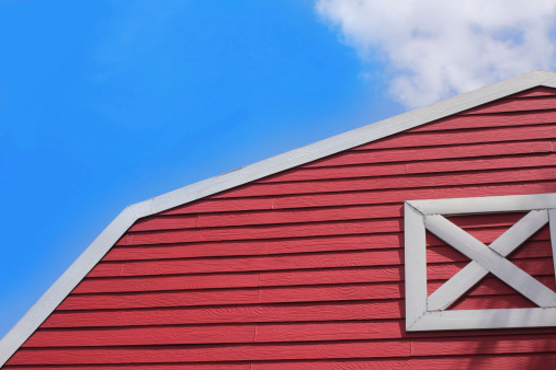 Red barn on blue sky