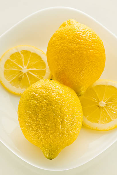 Two yellow lemon on a  white background stock photo