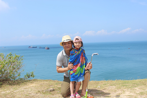 A family in their traveling to Danang, Vietnam. This is a famous city with a lot of nice beach.