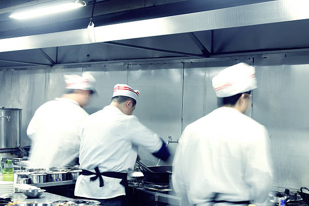 istock Busy chiefs in motion cooking in a restaurant 185621494