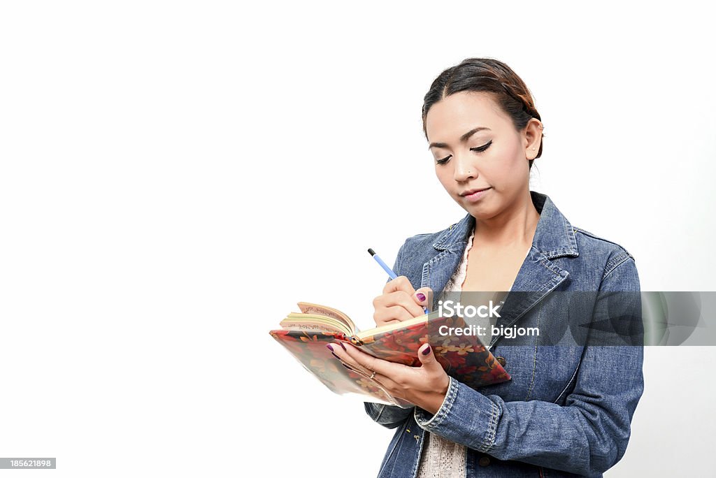 women write in a book working women write in a book Adult Stock Photo