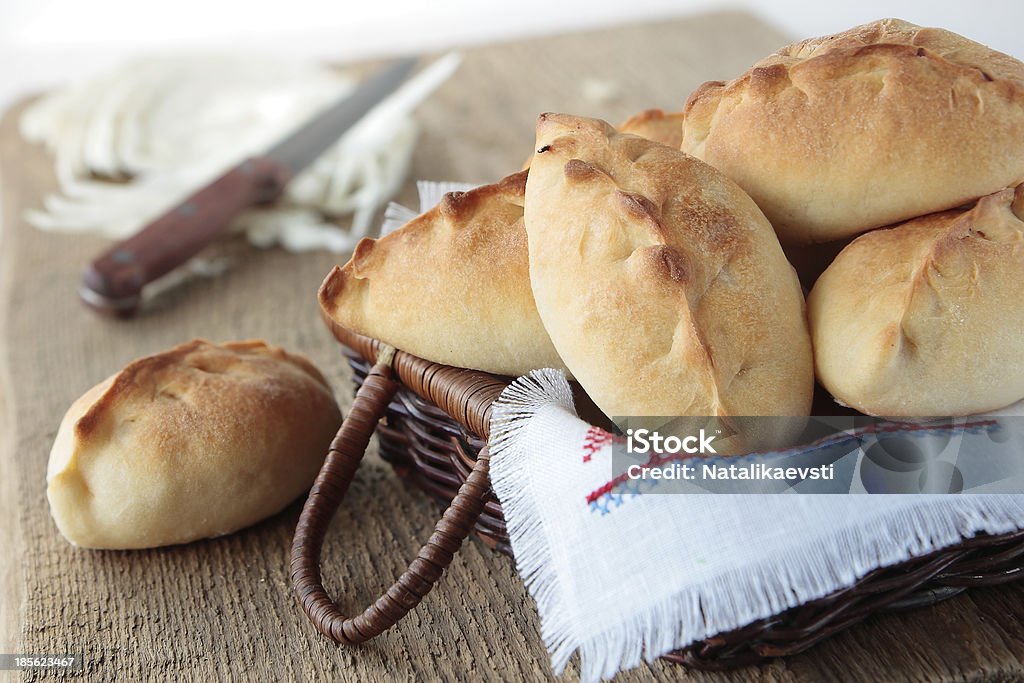 Basket with baked patties Basket with baked pies, knife, napkin, cabbage Baked Stock Photo