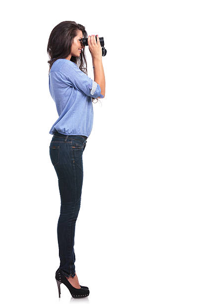 istock side of a casual woman looking through binoculars 185623749