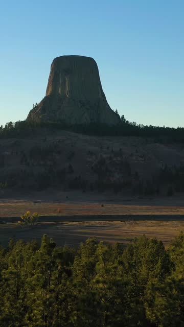 Devils Tower Butte at Sunset. Crook County Landscape, Wyoming. Aerial View. Vertical Video