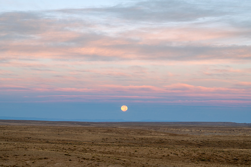 Moonset over barren land, Valley of Dreams, New Mexico, USA
