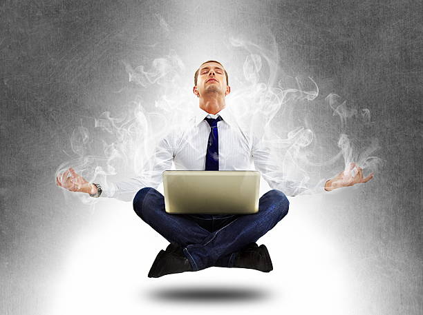istock yoga businessman in total concentration with laptop 185627217