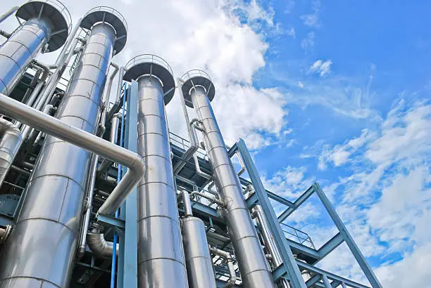 Photo of Looking up at chemical plant stacks