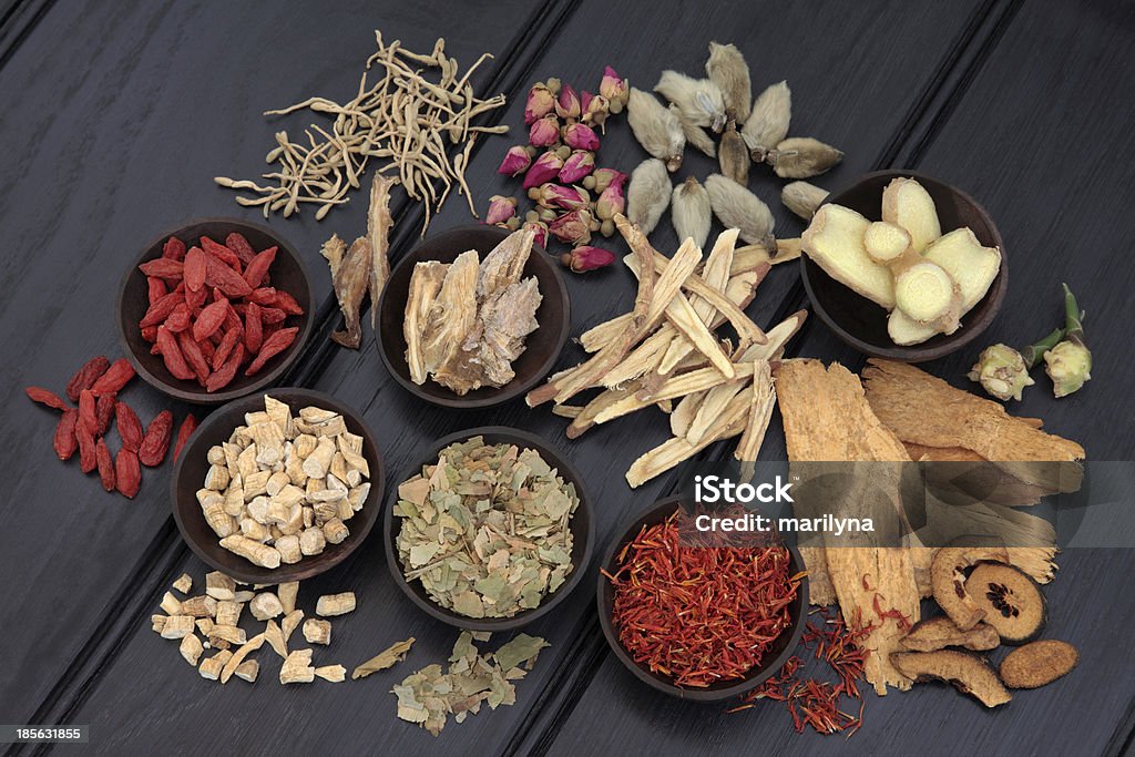 Herbal Therapy Chinese herbal medicine selection in wooden bowls and loose. Alternative Medicine Stock Photo