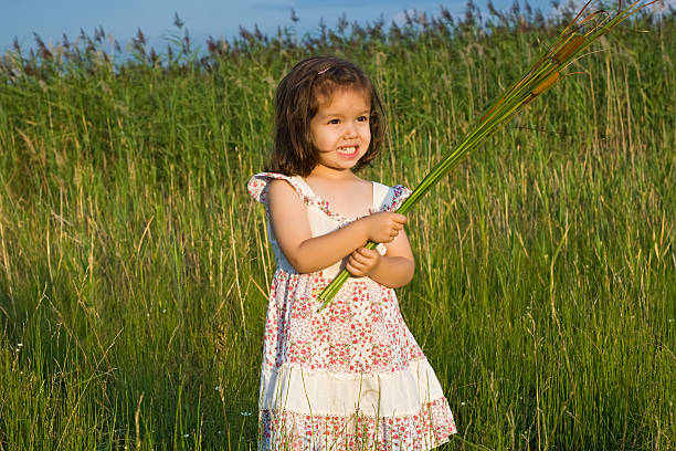 Girl enjoys in nature,sitting on the grass.