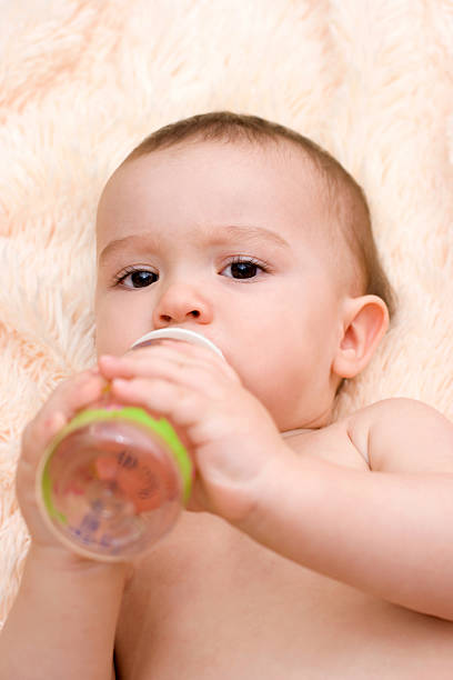 istock Little caucasian boy drinking from the bottle 185636258