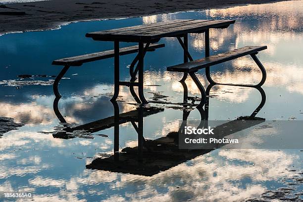 Picnic Table In Water With Reflected Sky Stock Photo - Download Image Now - Beach, Blue, Canada