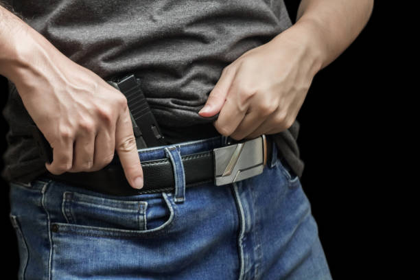 istock Man drawing a conceal carry pistol from a holster 1856375071