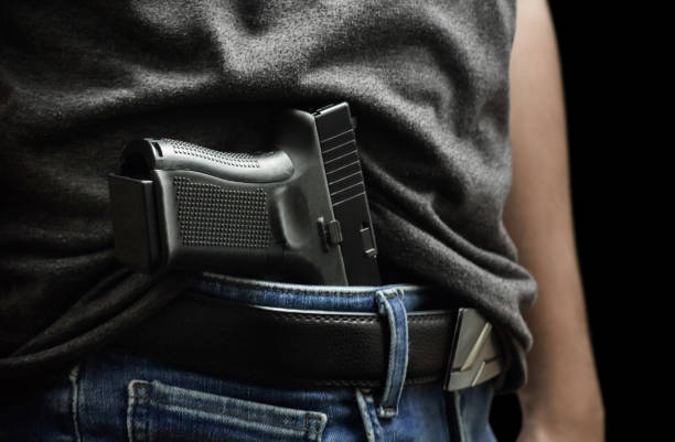 Man drawing a conceal carry pistol from a holster