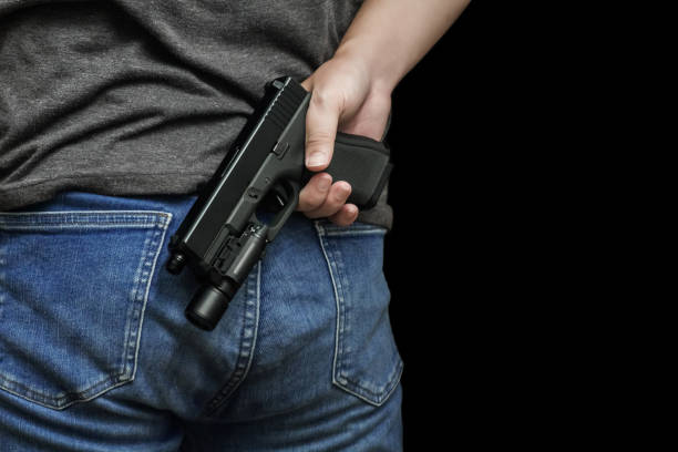 istock Man drawing a conceal carry pistol from a holster 1856375621