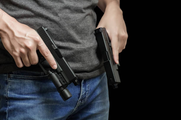 istock Man drawing a conceal carry pistol from a holster 1856376133