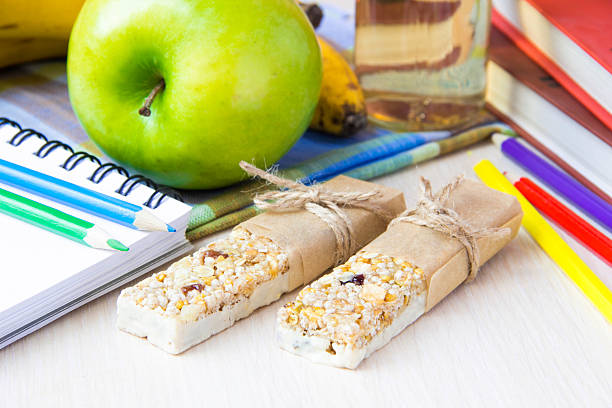 Healthy school lunch for kids with stick muesli and apple stock photo