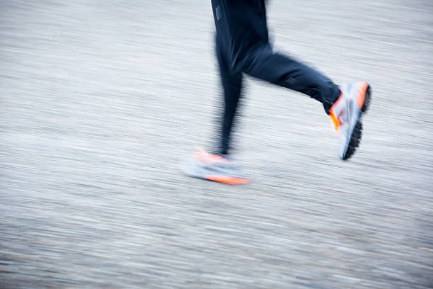 istock Motion blurred runner's feet in a city 185640768